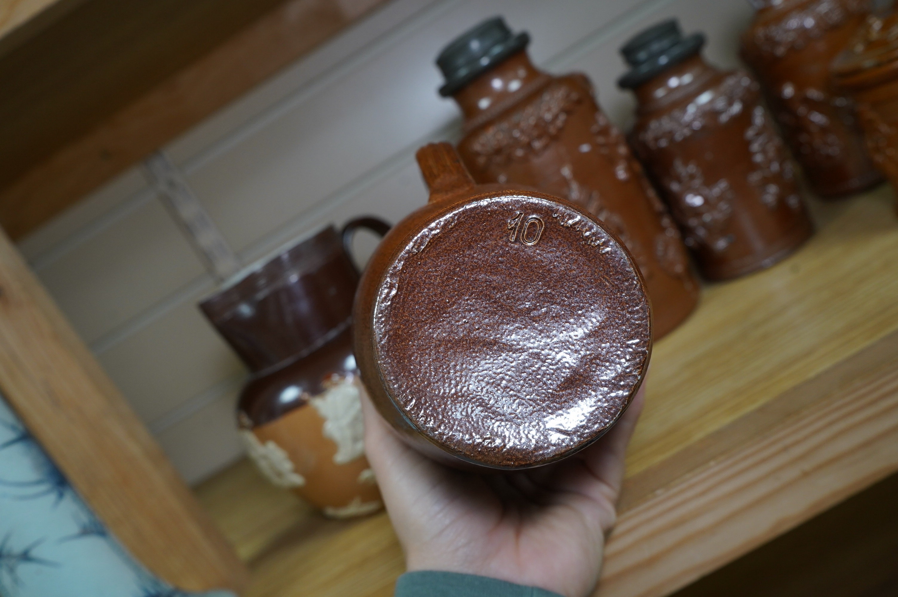 Four 19th century Derbyshire lead glazed stoneware jars and a stoneware jug and another, tallest 21cm (6). Condition - poor to fair